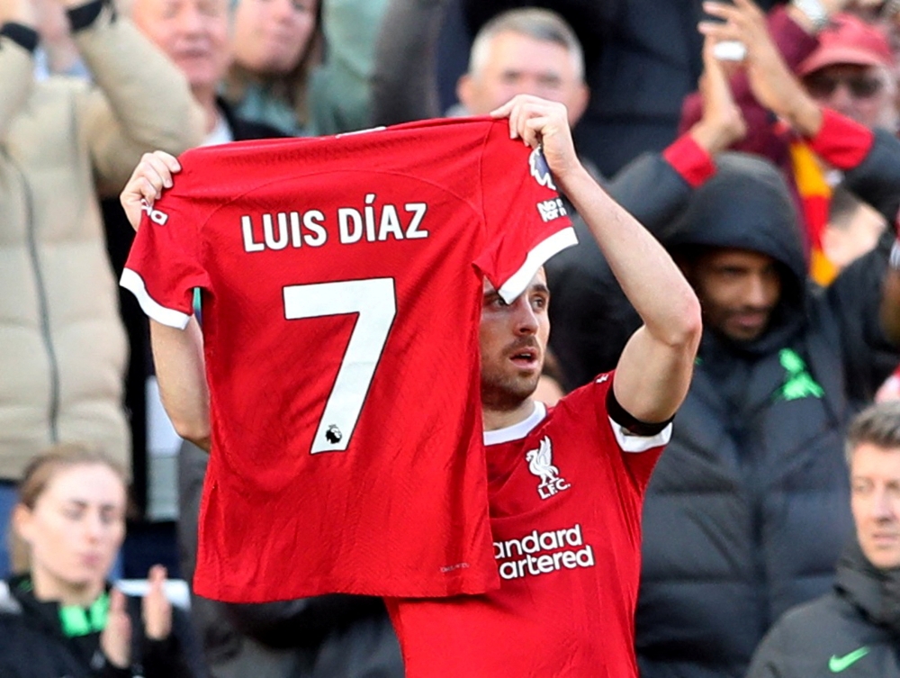 Liverpool's Diogo Jota holds up a shirt in support of Liverpool's Luis Diaz as he celebrates scoring their first goal during the match against Nottingham Forest at Anfield, Liverpool October 29, 2023. — Reuters pic