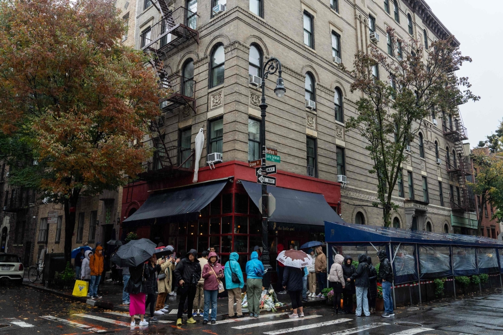 People stand in line to pay tribute to actor Matthew Perry outside the apartment building which was used as the exterior shot in the TV show ‘Friends’ in New York. 