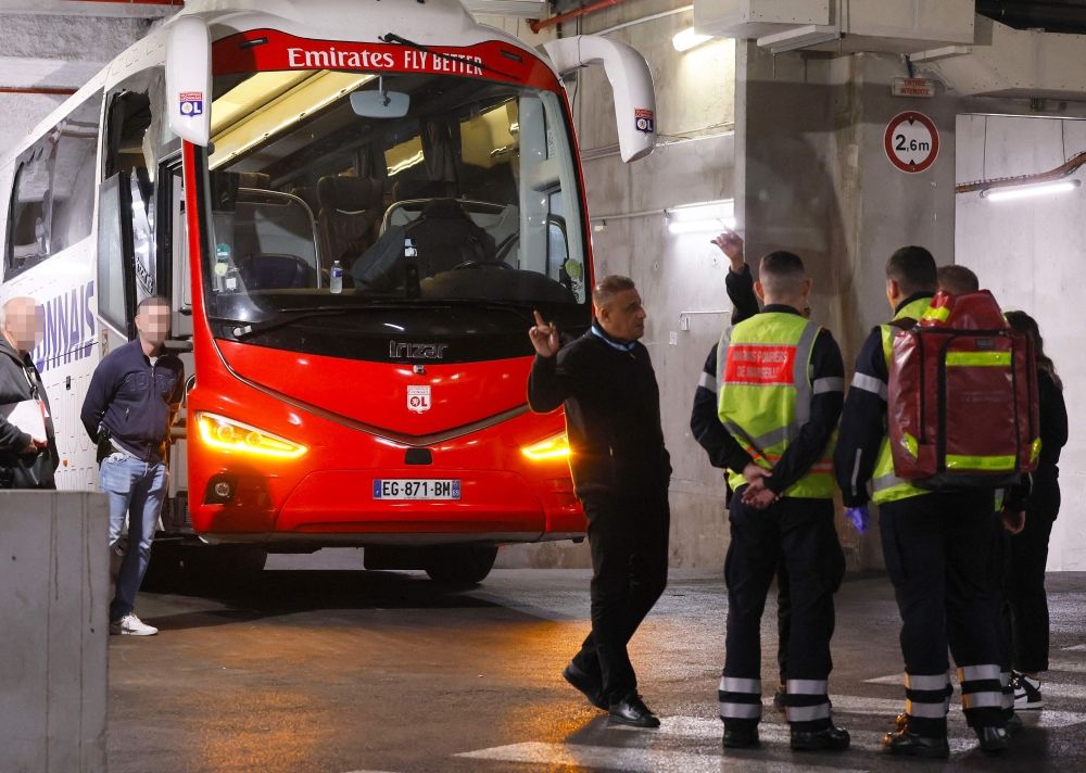 Firefighters stand next to Lyon’s team bus, showing one window (left) completely broken and another damaged, after the bus was stoned as it entered the Stade Velodrome ahead of the French L1 football match between Olympique Marseille and Olympique Lyonnais at Stade Velodrome in Marseille, southern France on October 29, 2023. Lyon head coach Fabio Grosso was reportedly injured during the incident. — AFP pic 