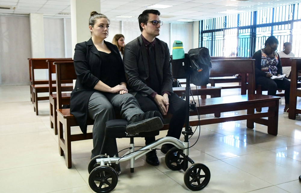 American couple Nicholas Spencer and his wife, Mackenzie Leigh Mathias Spencer, sit in the courtroom during the verdict where they are charged with torturing a ten-year-old John Kayima and state prosecutor objected to their application saying that the two have been illegally in Uganda after their work permits expired, at the High court in Kampala, Uganda, October 31, 2023. — Reuters pic