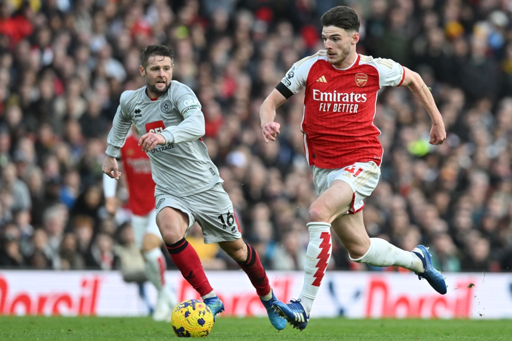 Arsenal’s English midfielder Declan Rice runs with the ball during the English Premier League football match between Arsenal and Sheffield United at the Emirates Stadium in London on October 28, 2023. — AFP pic 