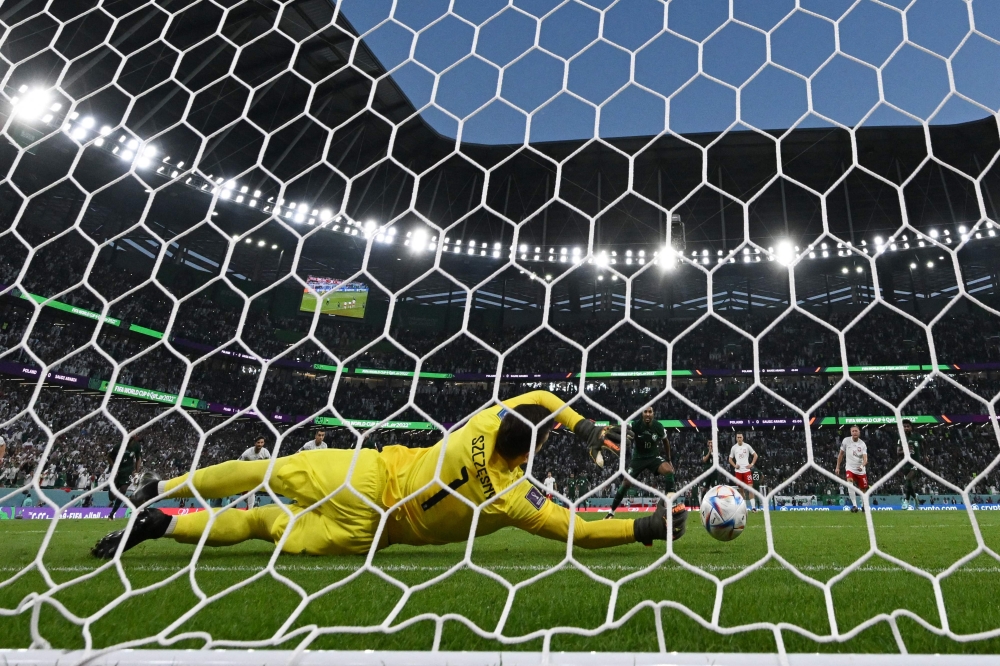 Poland's goalkeeper #01 Wojciech Szczesny stops a penalty by Saudi Arabia's midfielder #10 Salem Al-Dawsari during the Qatar 2022 World Cup Group C football match between Poland and Saudi Arabia at the Education City Stadium in Al-Rayyan, west of Doha on November 26, 2022. — AFP pic