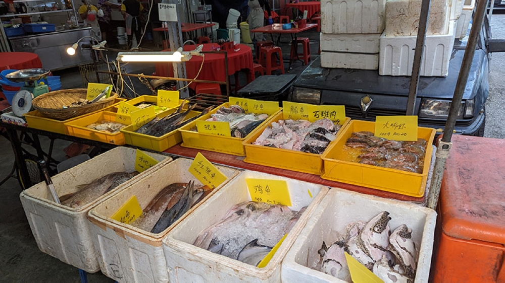 A cold room like no other, with grouper heads, whole fish and fresh prawns on ice.