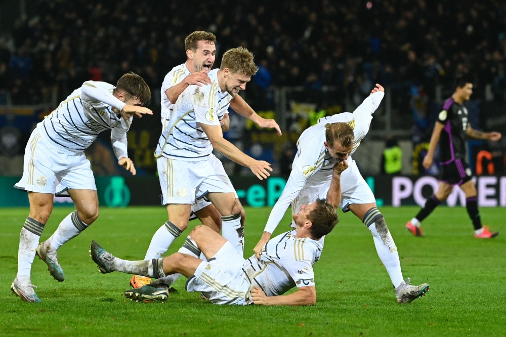 Saarbruecken's players celebrate after winning the German Cup (DFB Pokal) second round football match 1 FC Saarbruecken v FC Bayern Munich at Ludwigspark stadium in Saarbruecken, south-western Germany, on November 1, 2023. — AFP pic