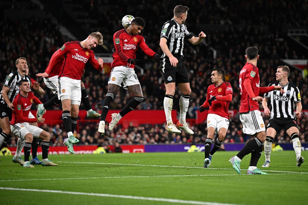 Manchester United's English striker #10 Marcus Rashford (C) heads the ball as he defends the goal from a corner shot during the English League Cup fourth round football match between Manchester United and Newcastle United at Old Trafford, in Manchester November 1, 2023. — AFP pic