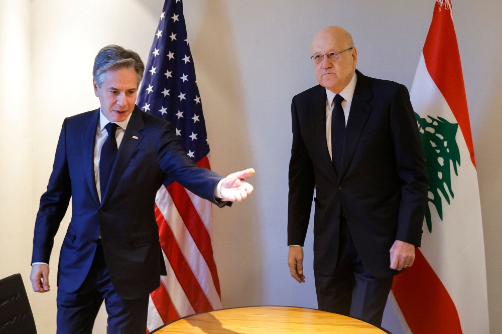 US Secretary of State Antony Blinken gestures towards Lebanon’s caretaker prime minister Najib Mikati to sit down at a hotel during a day of meetings, amid the ongoing conflict between Israel and the Palestinian group Hamas, in the Jordanian capital Amman on November 4, 2023. — AFP pic