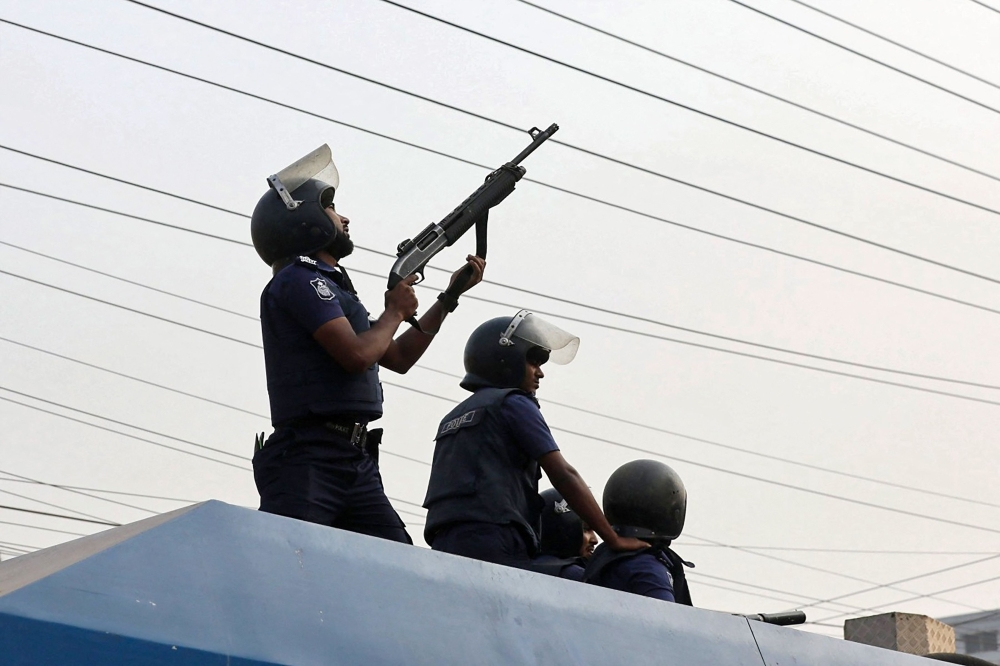 Police personnel fire rubber bullets to disperse garment workers staging a rally to demand a near-tripling of their wages in Ashulia on November 4, 2023. — AFP pic