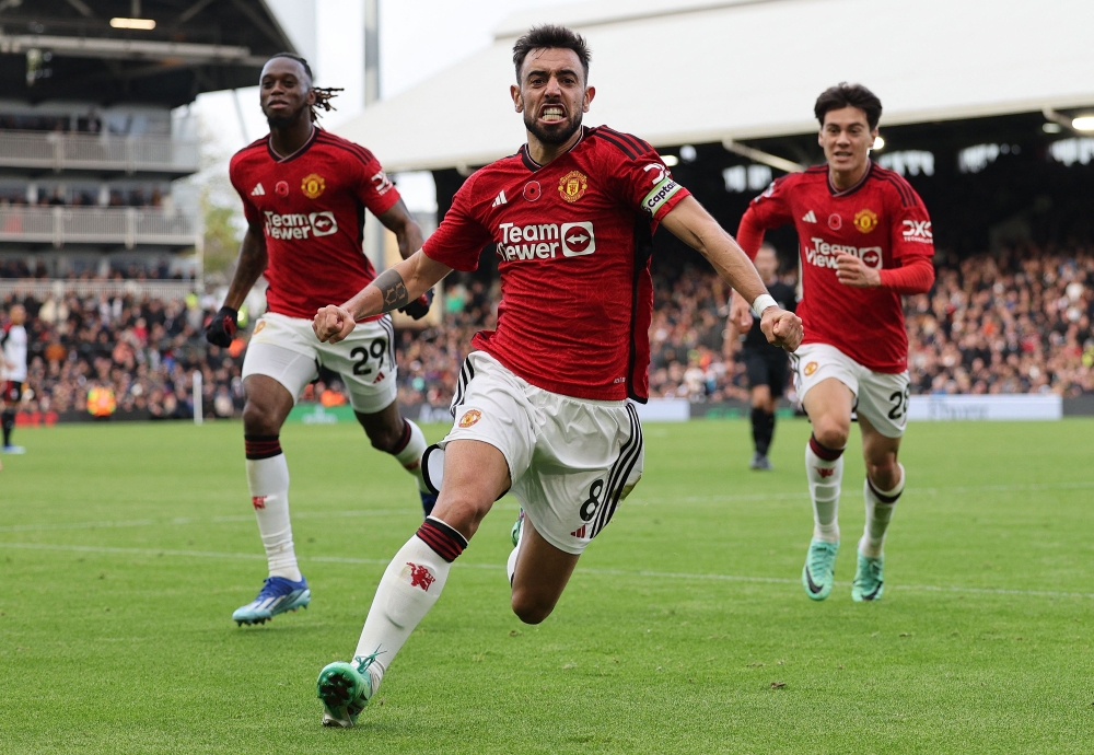 Manchester United’s Portuguese midfielder #08 Bruno Fernandes celebrates scoring the opening goal during the English Premier League football match between Fulham and Manchester United at Craven Cottage in London on November 4, 2023. — AFP pic