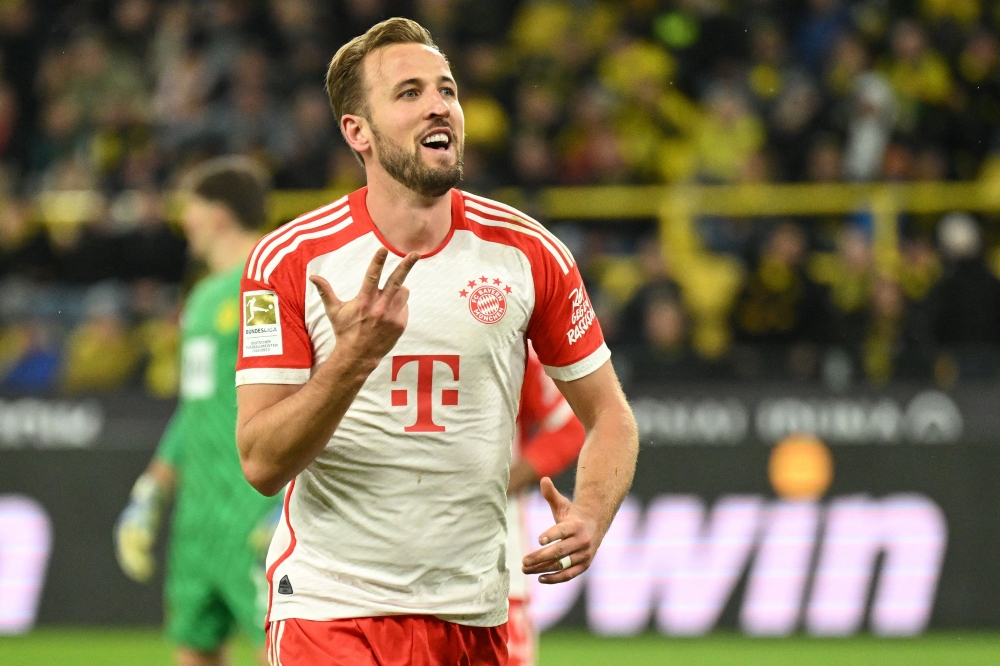 Bayern Munich's English forward #09 Harry Kane shows 3 fingers for his hattrick as he celebrates scoring the 0-4 during the German first division Bundesliga football match between BVB Borussia Dortmund and FC Bayern Munich in Dortmund, western Germany on November 4, 2023. — AFP pic