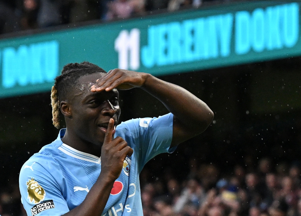 Manchester City's Belgian midfielder #11 Jeremy Doku celebrates scoring the opening goal during the English Premier League football match between Manchester City and Bournemouth at the Etihad Stadium in Manchester, north west England, on November 4, 2023. — AFP pic