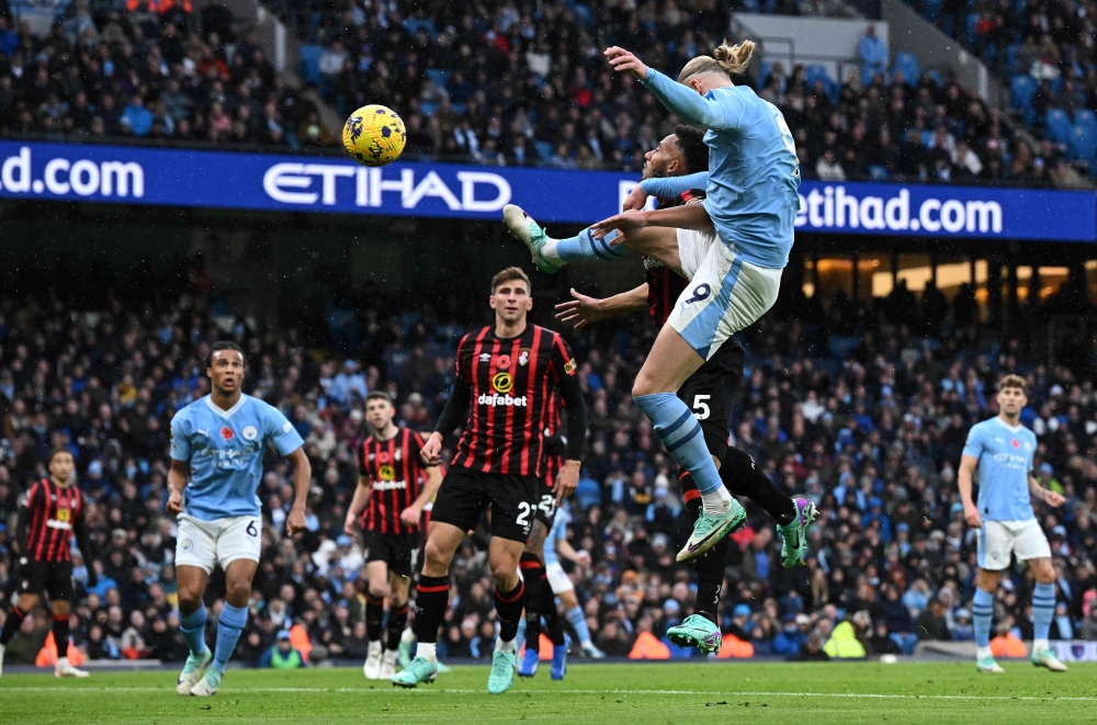 Manchester City's Norwegian striker #09 Erling Haaland unsuccessfully headers towards goal during the English Premier League football match between Manchester City and Bournemouth at the Etihad Stadium in Manchester, north west England, on November 4, 2023. — AFP pic