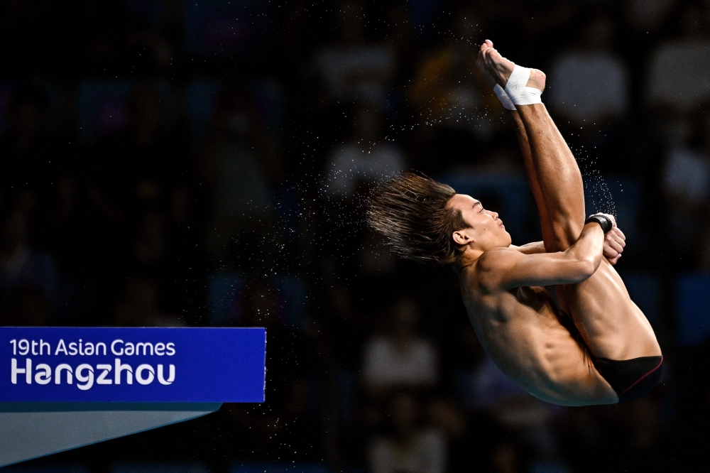 Malaysia’s Bertrand Rhodict Anak-Lises competes in the finals of the men's 10m platform diving event during the Hangzhou 2022 Asian Games in Hangzhou, in China's eastern Zhejiang province on October 4, 2023. — AFP pic