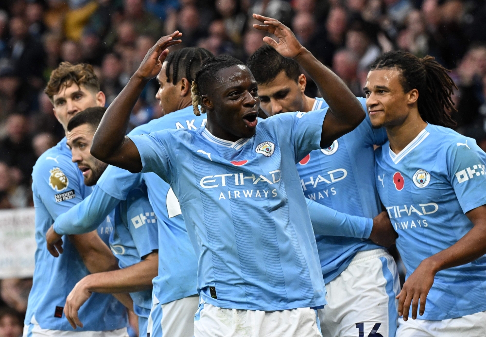 Manchester City's Belgian midfielder Jeremy Doku (centre) celebrates scoring the opening goal during the English Premier League football match between Manchester City and Bournemouth at the Etihad Stadium in Manchester, north west England November 4, 2023. — AFP pic