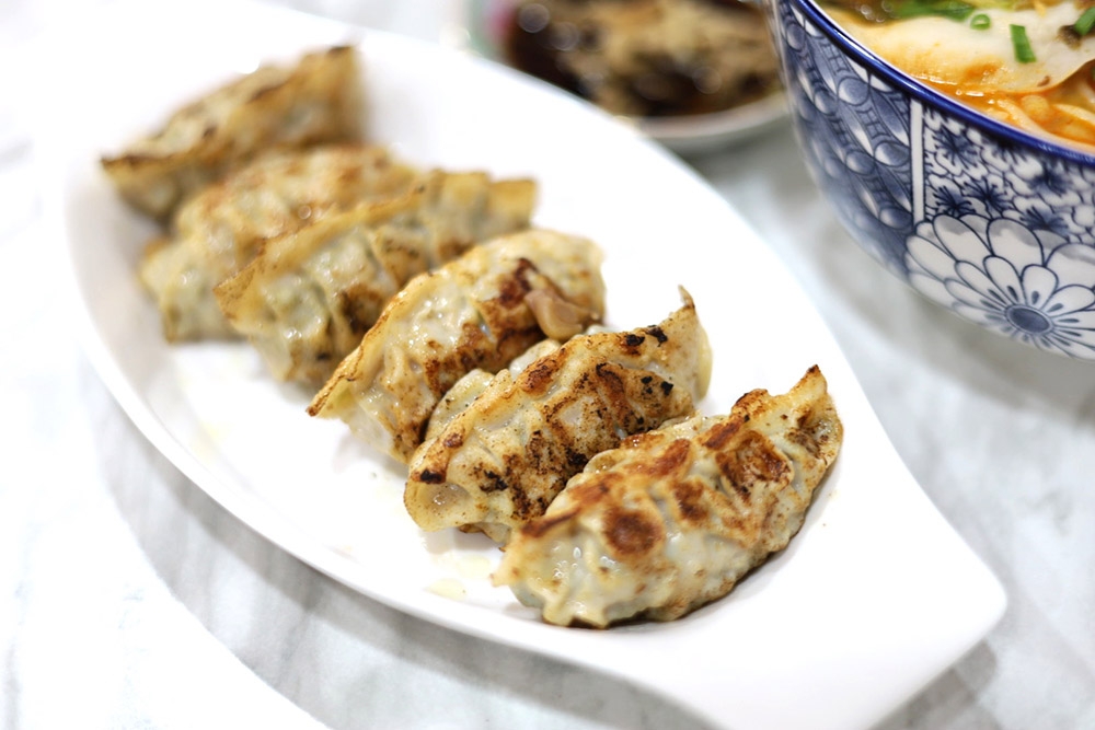 Fried Dumplings here taste homemade with a juicy filling of minced pork and vegetables.