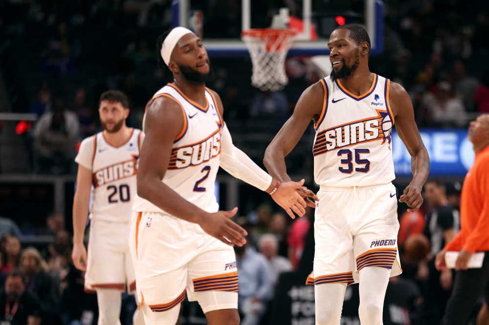 Kevin Durant (35) of the Phoenix Suns celebrates with Josh Okogie (2) in the second half on the way to a 120-106 win over the Detroit Pistons at Little Caesars Arena in Detroit, Michigan November 5, 2023. — Picture by Gregory Shamus/Getty Images via AFP