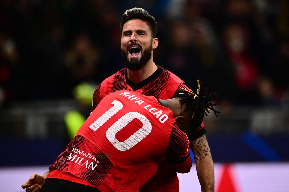 AC Milan's French forward #09 Olivier Giroud celebrates with AC Milan's Portuguese forward #10 Rafael Leao after scoring the team's second goal during the UEFA Champions League 1st round group F football match between AC Milan and Paris Saint-Germain at the San Siro stadium in Milan on November 7, 2023. — AFP pic