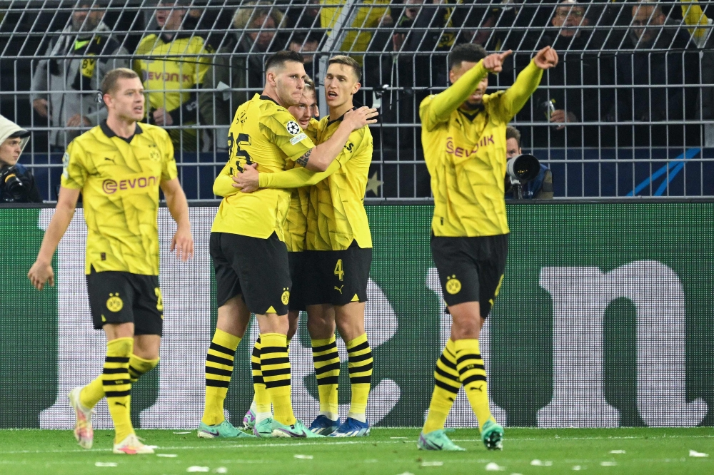 Dortmund's German midfielder #19 Julian Brandt celebrates scoring the 2-0 goal with his team-mates during the Uefa Champions League Group F football match between BVB Borussia Dortmund and Newcastle United FC in Dortmund, western Germany on November 7, 2023. — AFP pic