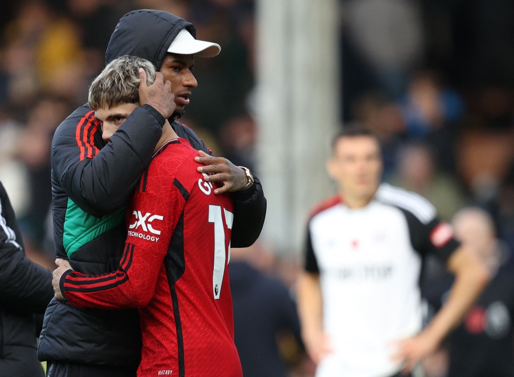 Manchester United's English striker #10 Marcus Rashford (C) embraces Manchester United's Argentinian midfielder #17 Alejandro Garnacho after the English Premier League football match between Fulham and Manchester United at Craven Cottage in London on November 4, 2023. — AFP pic