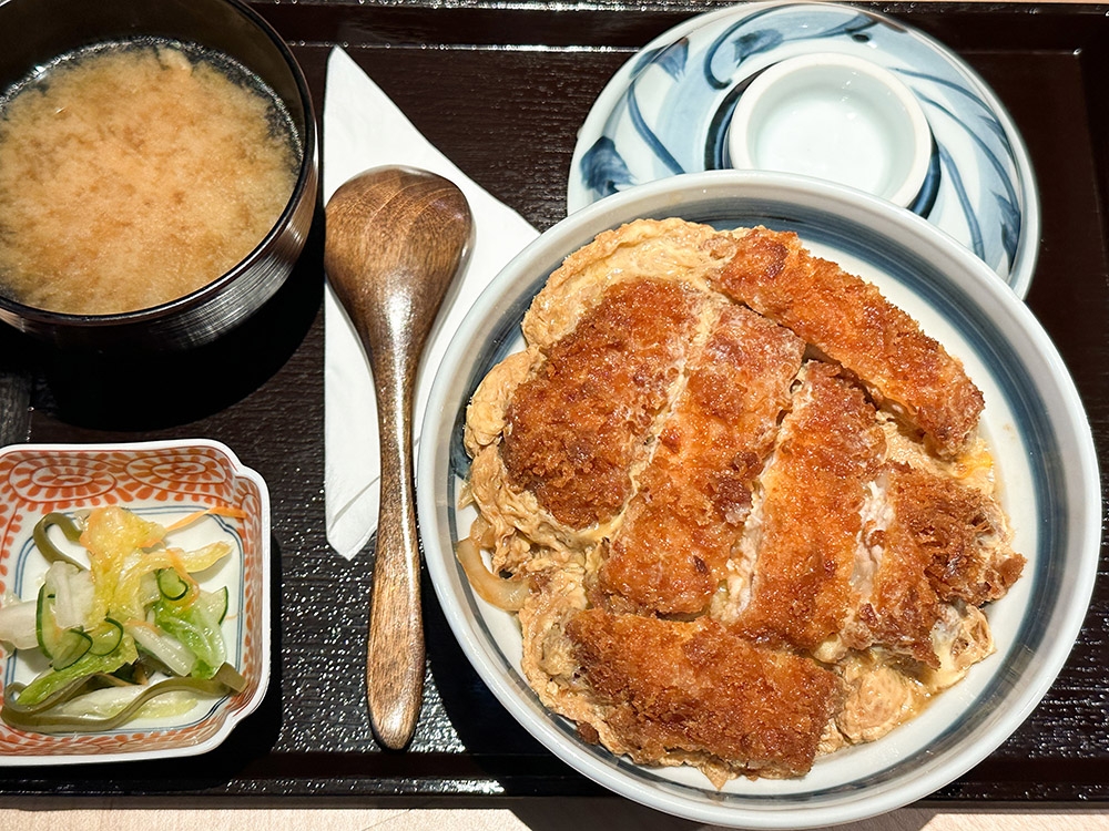 Loin Katsu Set matches 'tonkatsu' with egg and onions with rice for a satisfying meal.