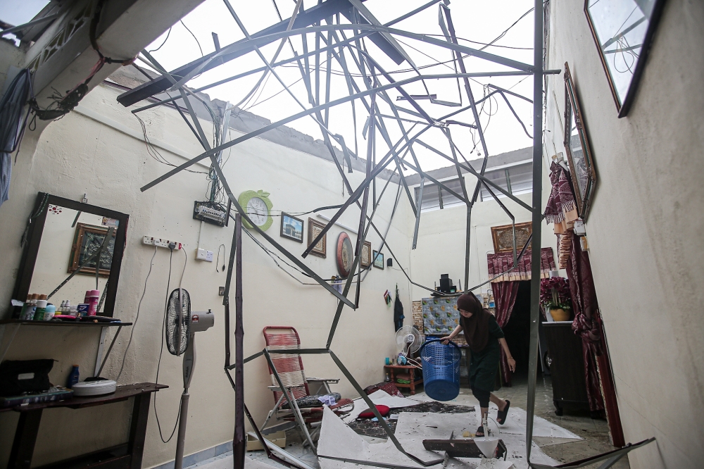 The damaged roof of a house in Taman Klebang Jaya is seen as residents clear up their homes following a storm in Ipoh November 8, 2023. — Picture by Farhan Najib