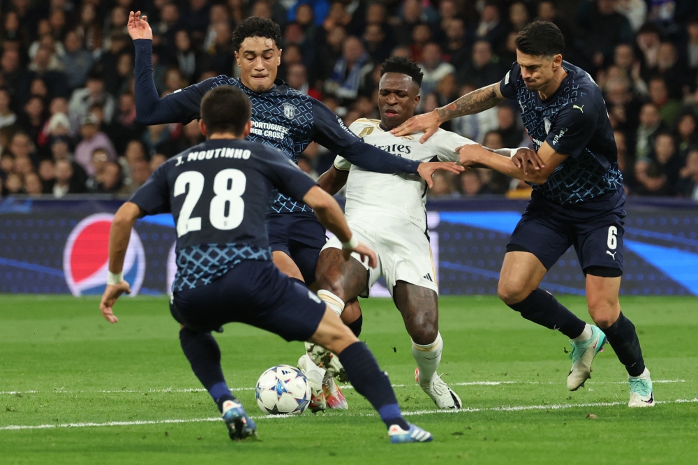 Real Madrid forward Vinicius Junior is challenged by Sporting Braga midfielder Vitor Carvalho and defender Jose Fonte during the Uefa Champions League group C football match between Real Madrid CF and SC Braga at the Santiago Bernabeu stadium in Madrid on November 8, 2023. — AFP pic 