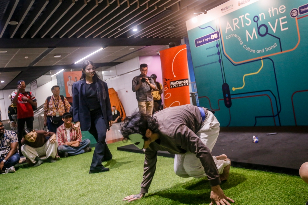 The young performers drew a crowd of commuters at the station which is one of the busiest interchange stations in Kuala Lumpur, especially during peak hours. — Picture by Hari Anggara.