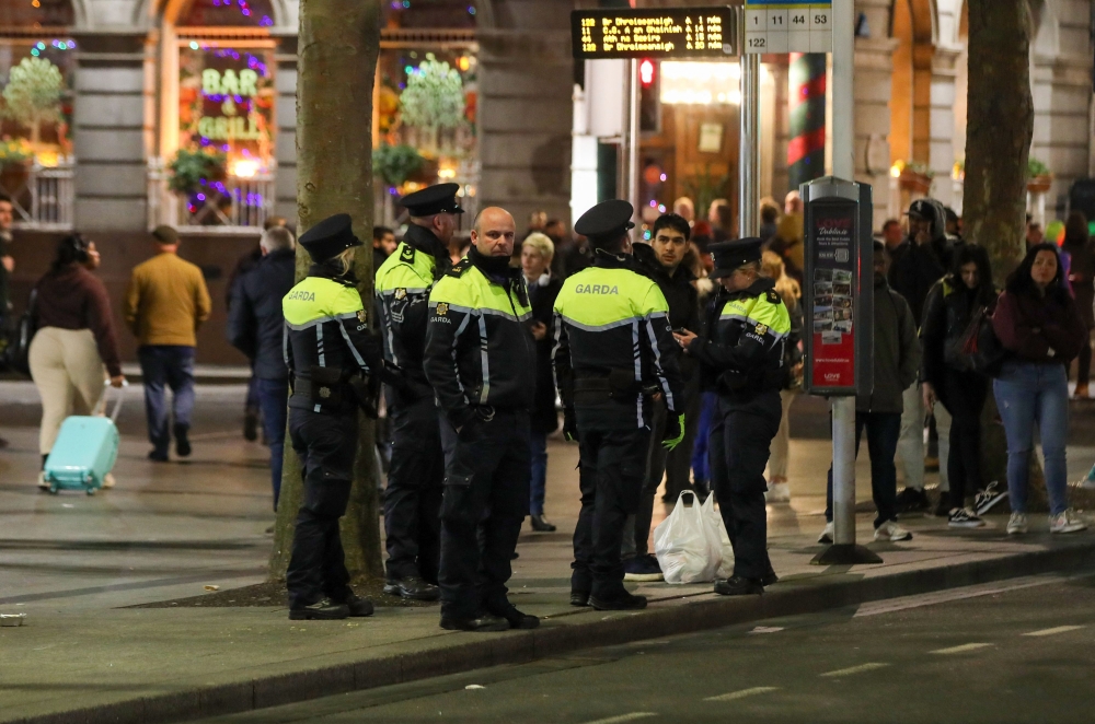 File photo of Ireland’s Garda police officers standing on duty at a bus stop on O’Connell Street in Dublin on November 24, 2023. — AFP pic