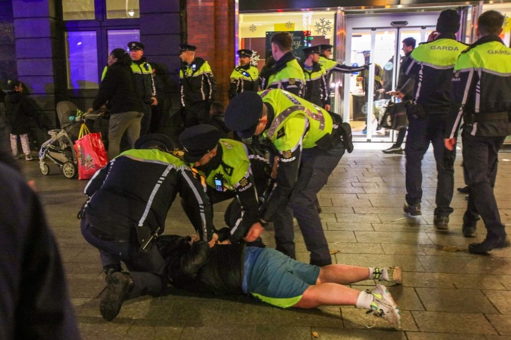 File photo of Ireland’s Garda police officers making an arrest on O'Connell Street in Dublin on November 24, 2023. — AFP pic