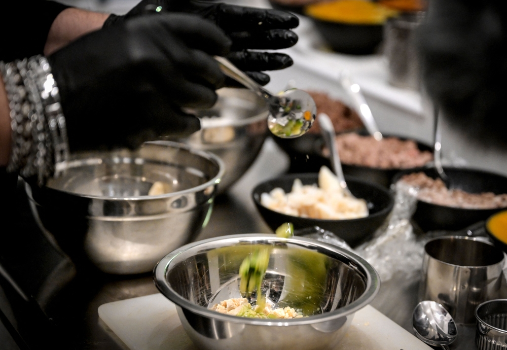 This photograph taken on November 21, 2023 shows a dish for dogs being prepared at the Fiuto restaurant in Rome. — AFP pic