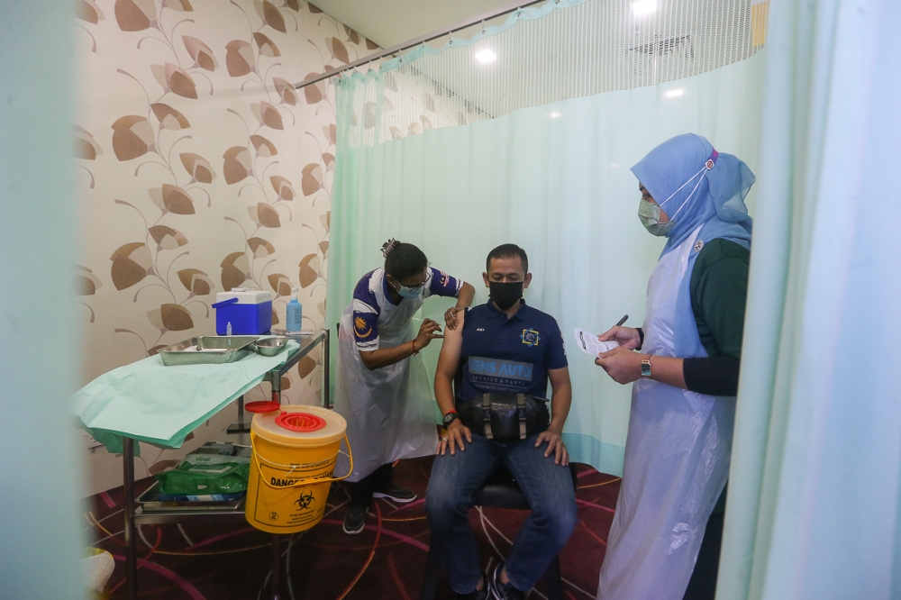 A health worker receives his second dose of Pfizer-BioNTech Covid-19 vaccine during a vaccination programme at the KPJ Selangor Specialist Hospital in Shah Alam in this file photo taken on May 25, 2021. Association of Private Hospitals of Malaysia’s president Datuk Dr Kuljit Singh said all hospitals are now accustomed to the management of Covid-19 cases and the protocols involved. — Picture by Yusof Mat Isa