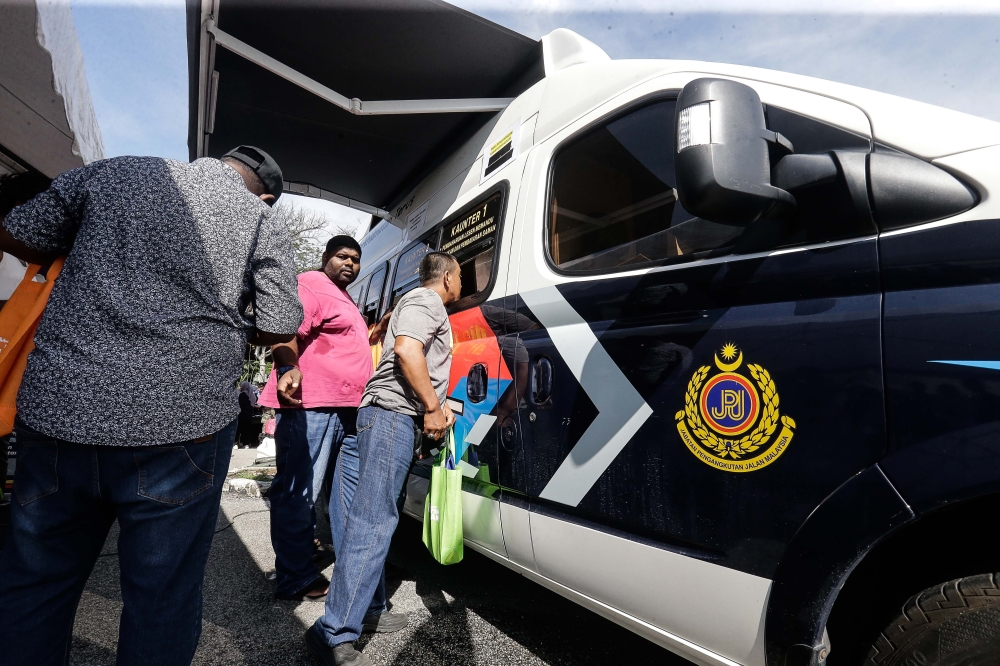 Visitors are seen at the Road Transport Department (JPJ) booth during the Madani Government One Year Anniversary Programme at the Bukit Jalil National Stadium December 10, 2023. — Picture by Sayuti Zainudin