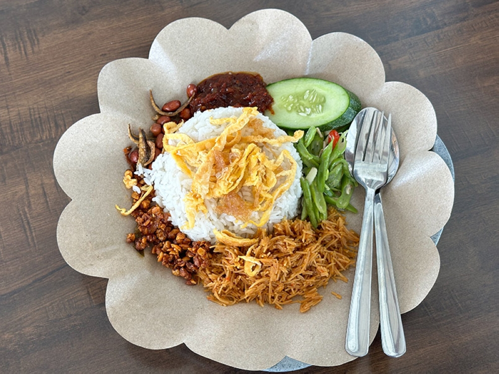 Try the Nasi Uduk which is similar to 'nasi lemak' but with added goodies like omelette strips, 'tempe', French beans and fried beehoon