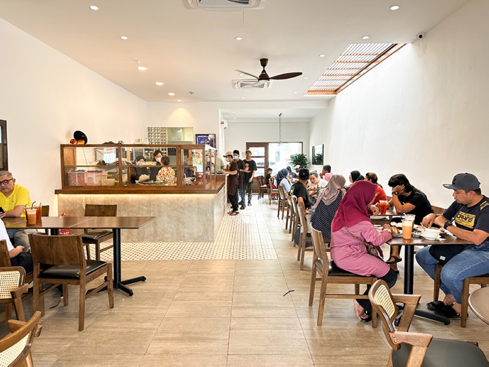 Queue at the counter to place your order and peer at the cabinet to see what dishes to order