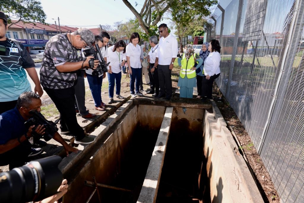 Penang Water Supply Corporation chief executive officer K. Pathmanathan and his team check on another valve at the Sungai Dua Water Treatment Plant that needs to be replaced, December 13, 2023. — Picture by Opalyn Mok