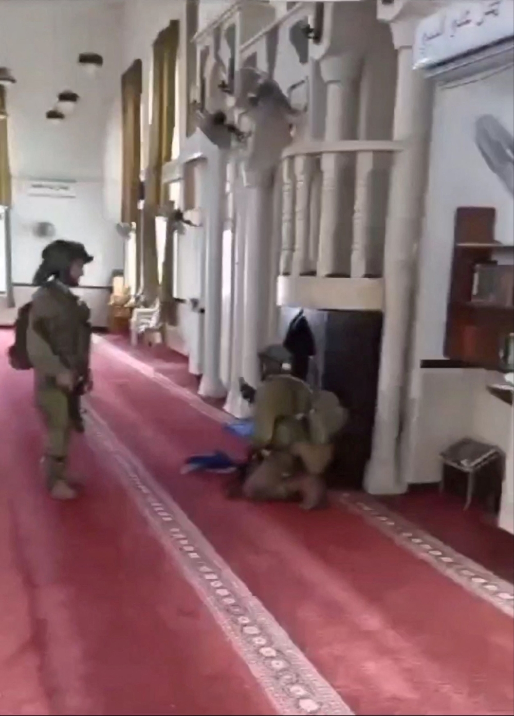 An Israeli soldier sings into a microphone inside a mosque, amid the ongoing conflict between Israel and the Palestinian Islamist group Hamas, in Jenin, in the Israeli-occupied West Bank in this screen grab from a video released December 14, 2023 and obtained by Reuters. — Video obtained by Reuters