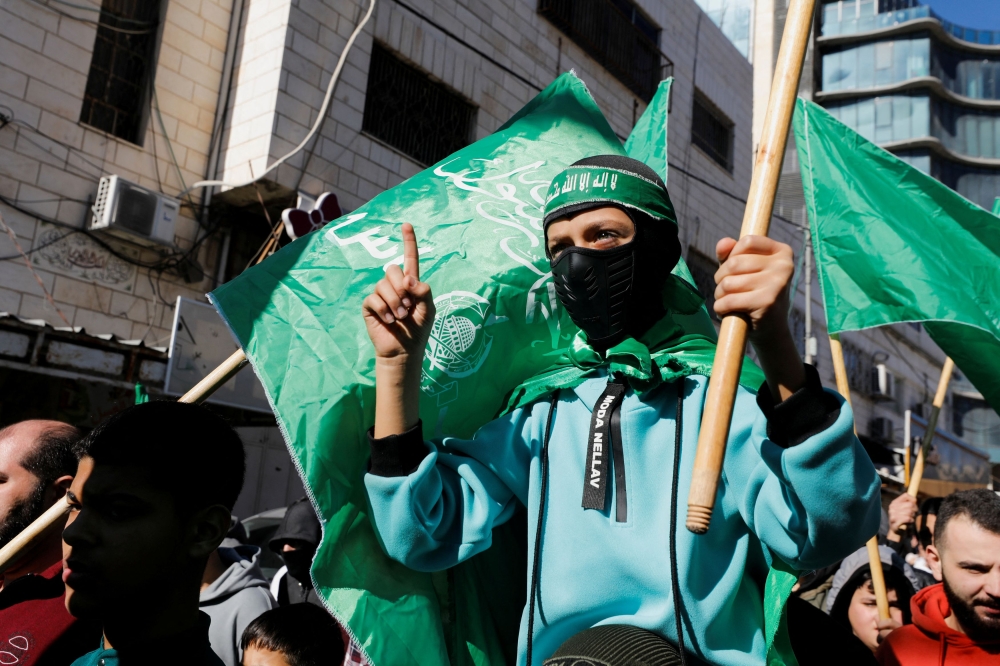 People march as they take part in a protest in support of Palestinians in Gaza, amid the ongoing conflict between Israel and the Palestinian Islamist group Hamas, in Hebron, in the Israeli-occupied West Bank, December 15, 2023. — Reuters pic