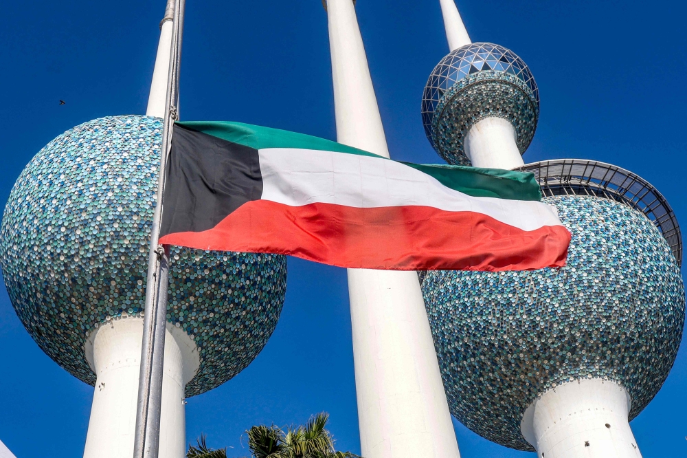 Kuwait’s national flags are lowered to the half-mast position outside the landmark Kuwait Towers in Kuwait City on December 16, 2023, as the Gulf country mourns the death of its leader the late emir Sheikh Nawaf al-Ahmad Al-Sabah. — AFP pic