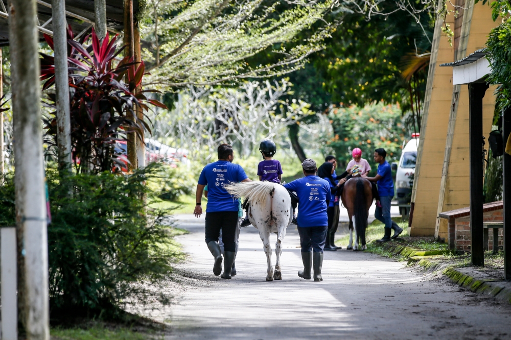 Special needs children attending hippotherapy sessions at Green Apple Hippotherapy at Selangor Turf Club in Serdang, December 10, 2023. — Picture by Hari Anggara