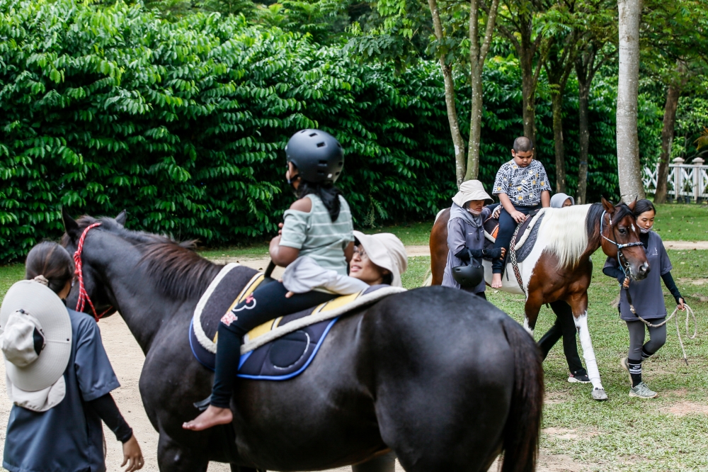 Special needs children attending hippotherapy sessions in the Horse Unit Complex at Happy Farms Hippotherapy in Putrajaya, December 10, 2023. — Picture by Hari Anggara