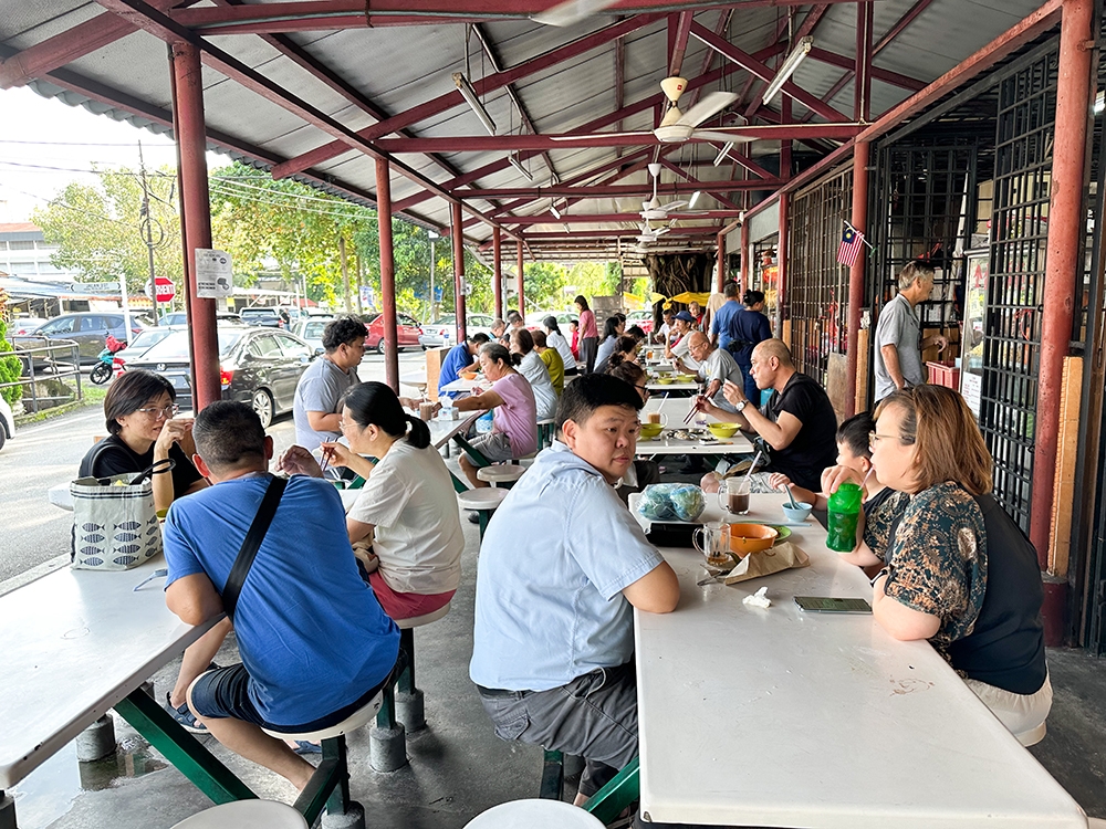 The crowd on Sunday is mainly families who will order the chicken with the noodles, or 'wantan mee' which is nearby