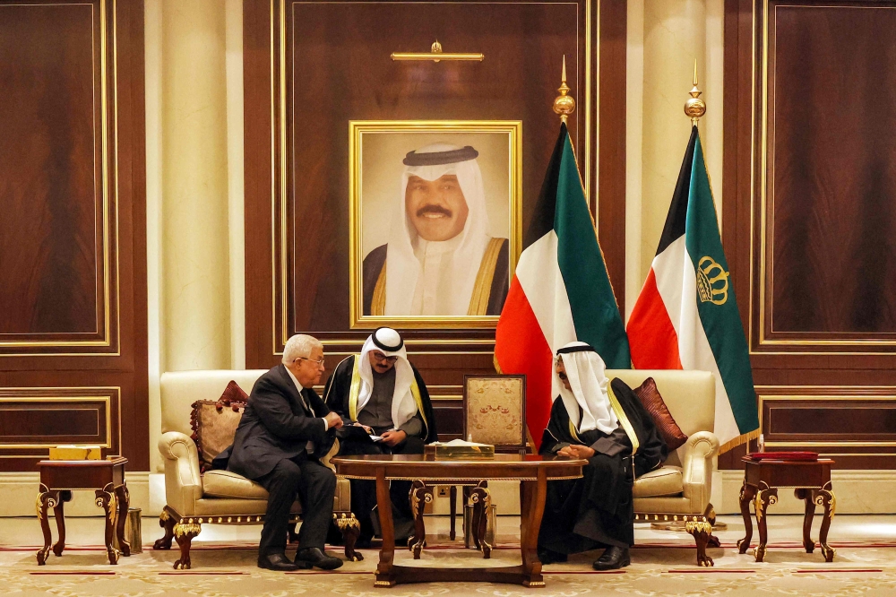 A handout picture provided by the Palestinian Authority's press office shows Palestinian president Mahmud Abbas (left) offering his condolences to Kuwait's new Emir Sheikh Meshal al-Ahmad al-Jaber al-Sabah (R) after the passing of his predecessor and half-brother Sheikh Nawaf Al-Ahmad Al-Jaber Al-Sabah, in Kuwait City on December 17, 2023. — Thaer Ghanaim/PPO/AFP pic