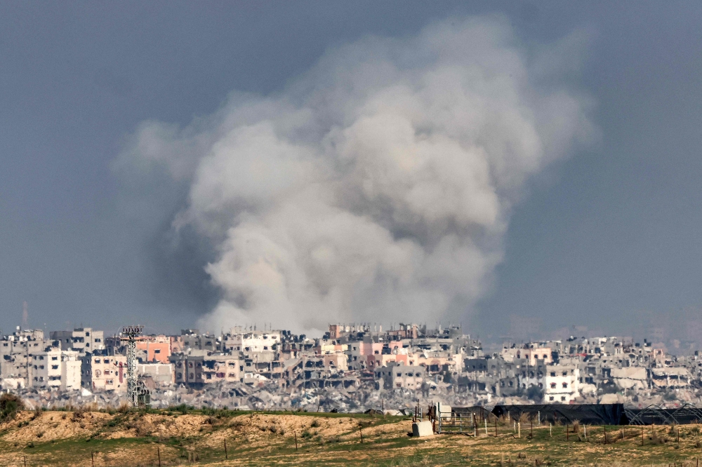 A smoke plume erupts during Israeli bombardment on the northern Gaza Strip near the border with southern Israel on December 17, 2023 amid continuing battles between Israel and the militant group Hamas. — AFP pic