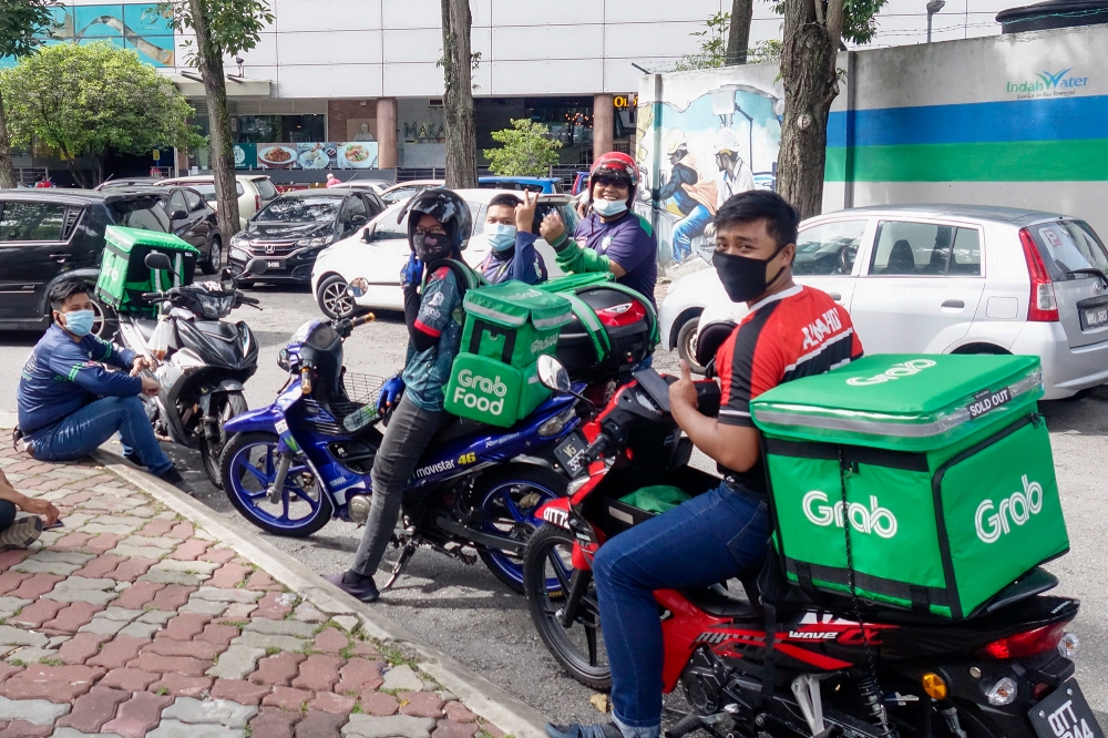 In Malaysia, around 26 per cent of the workforce participates in the gig economy, primarily through online-to-offline on-demand apps like ride-hailing and food delivery. — Picture by Shafwan Zaidon