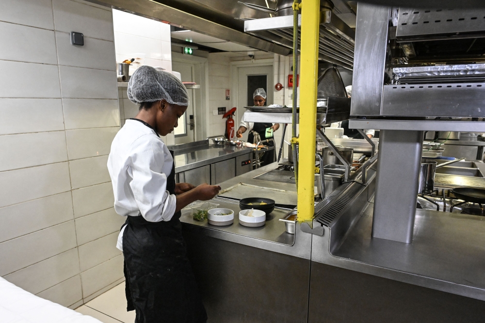 Chef Hermence Kadio prepares puffed cassava chips, grilled okra placali at the Maison Palmier restaurant in Abidjan on October 30, 2023. — AFP pic 