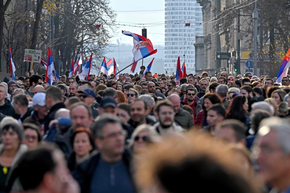 Protesters wave Serbian flags as they go to a rally of 'ProGlas', a Serbian pro-democracy motion, to oppose versus declared electoral scams, in Belgrade, on December 30, 2023.-- AFP pic