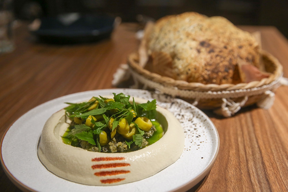 Charred Chillies Hummus is refreshed with an unusual mix of charred chillies, olives, coriander oil and 'daun selom'.