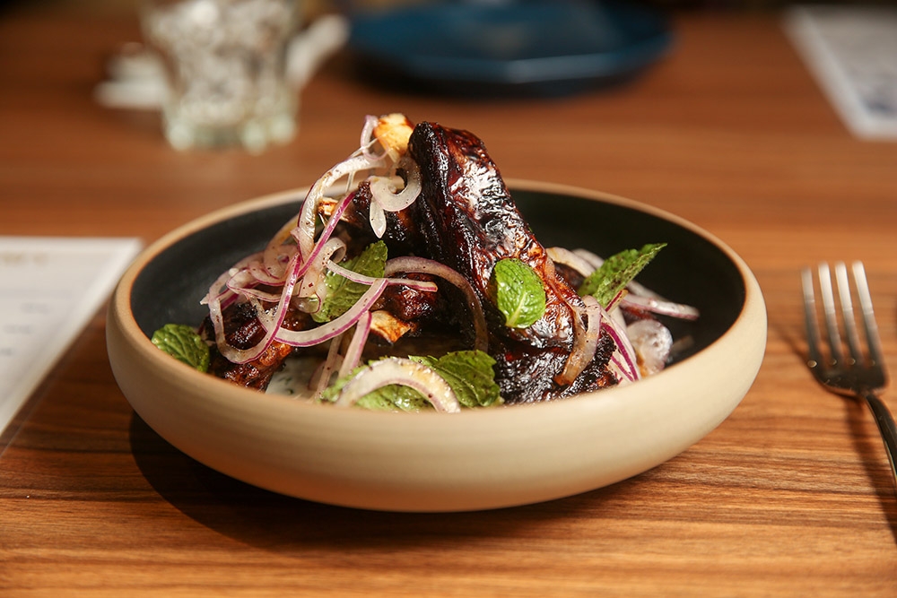 Glorious Lamb Ribs, perfectly cooked with meat that falls off the bone, is paired with a mint leaf salad and smoked Greek yoghurt.