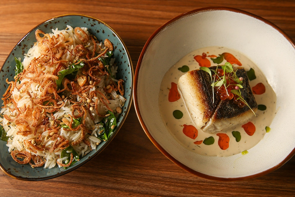 Sayadieh or Fish Rice is split into two separate dishes to allow the diner to enjoy the textures of the pilaf rice topped with fried shallots, with the dry aged Spanish mackerel served on top of tarator and crowned with ikura.