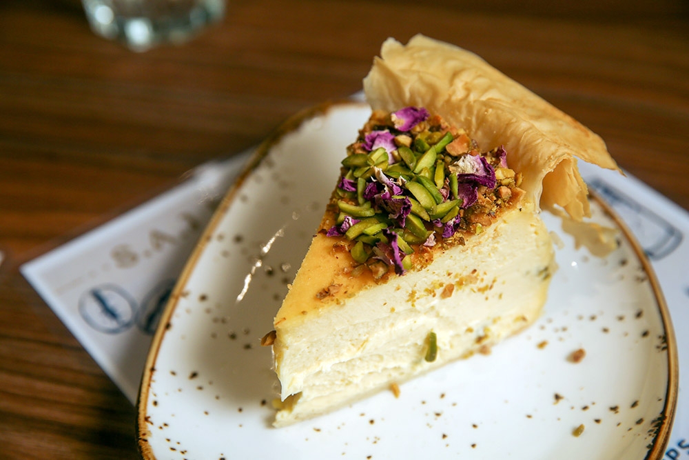 Baklava Cheesecake is a dessert worth craving for as the voluptuously creamy cheesecake is wrapped with filo pastry and topped with rosebuds and pistachios.