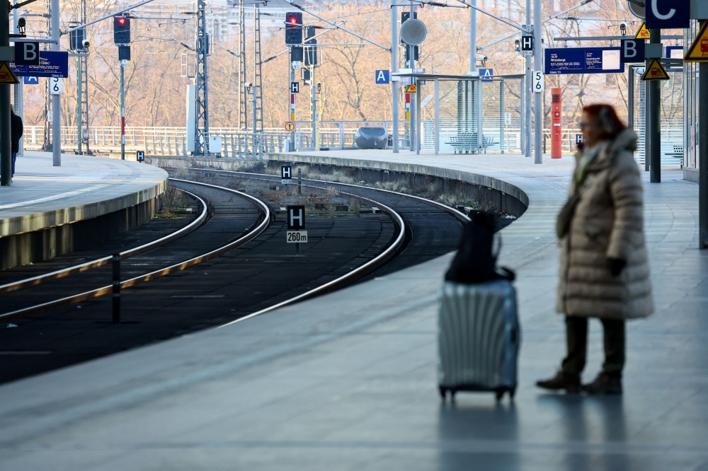 A passenger stands on a platform next to empty railway tracks at Berlin Hauptbahnhof main train station during a strike by Germany's GDL train drivers union, demanding wage increases and a shorter working week, in Berlin January 10, 2024. — Reuters pic  